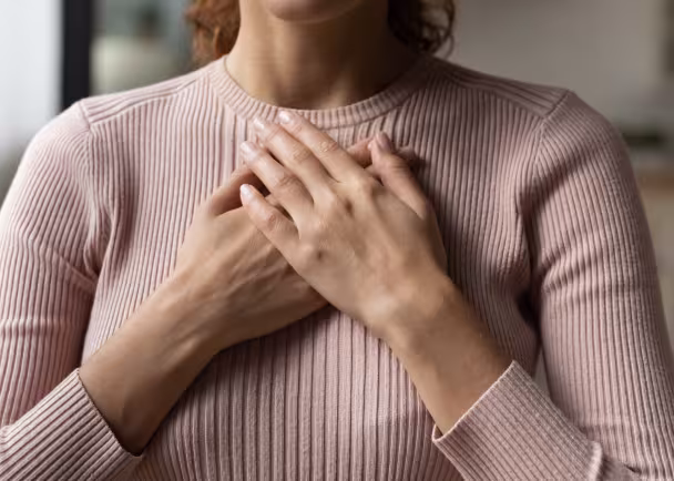 woman hands on chest