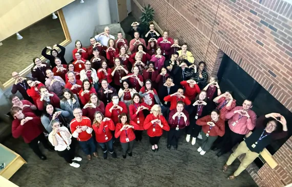 mhif staff holding up hearts