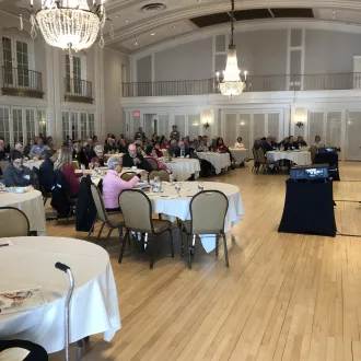 Dr. Nadira Hamid speaking to a room full of people