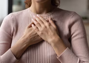 woman hands on chest